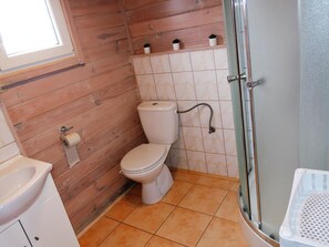 A small bathroom with a toilet, sink, and shower. - Holiday Home in Kolczewo Near Baltic Sea (gmina Wolin)