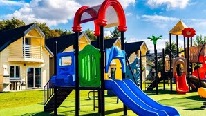 A playground with slides and climbing structures, surrounded by houses. - Single-story Holiday Home, Pool, Jacuzzi (Ustronie Morskie)