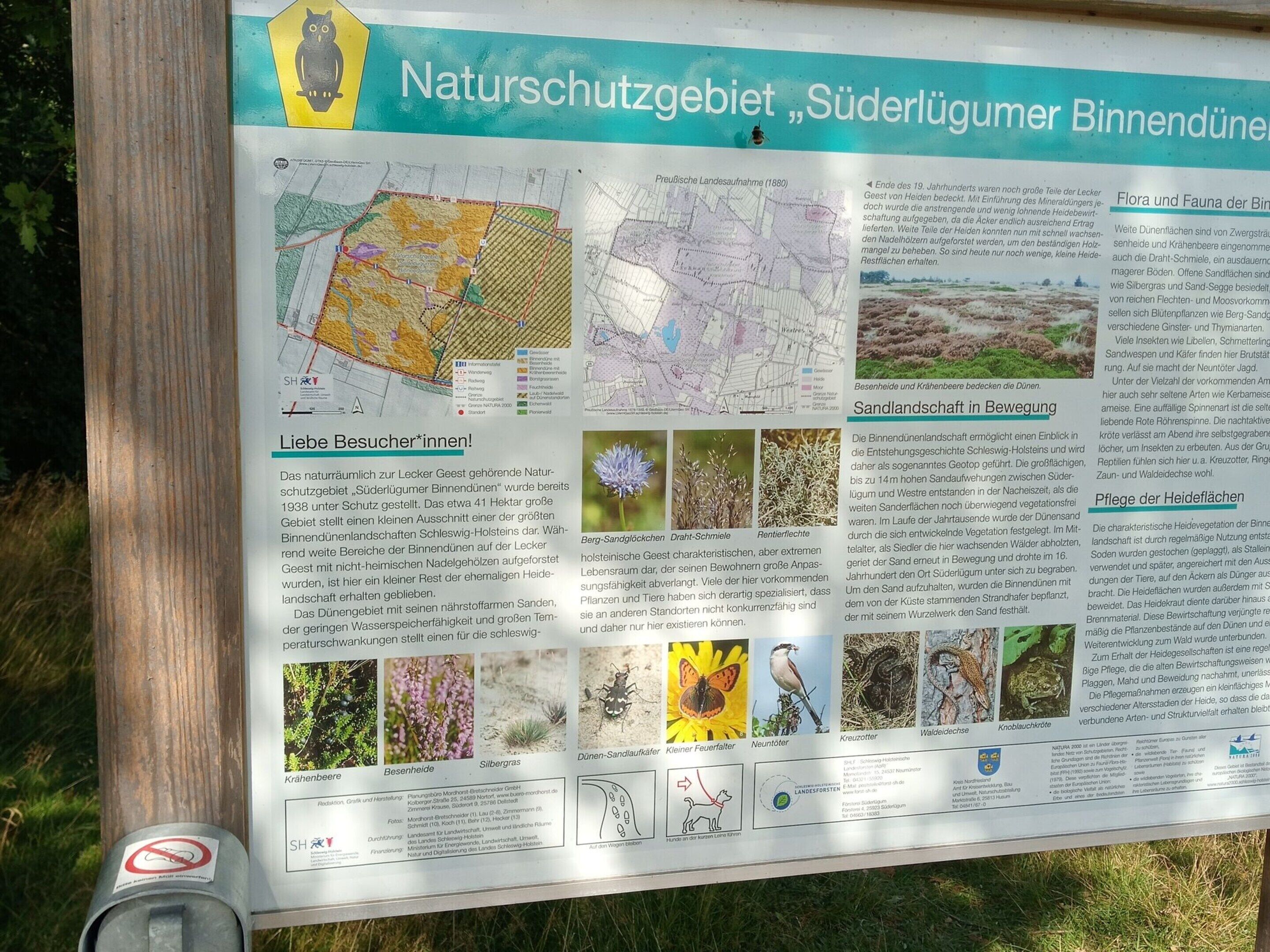A detailed informational sign about a nature reserve, including maps and descriptions of flora and fauna.