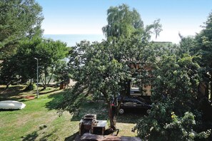 A backyard with a barbecue grill, a car, and a boat. - Holiday Home in Sulomino With Private Beach (gmina Wolin)