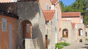 A street with stone buildings, some with arched doorways and tiled roofs. - Family Fun at Zaton Resort (Nin)