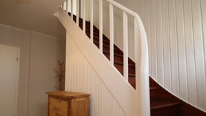 A staircase with white railings and wooden steps. - House in Dornumersiel Near Sandy Beach (Dornum)