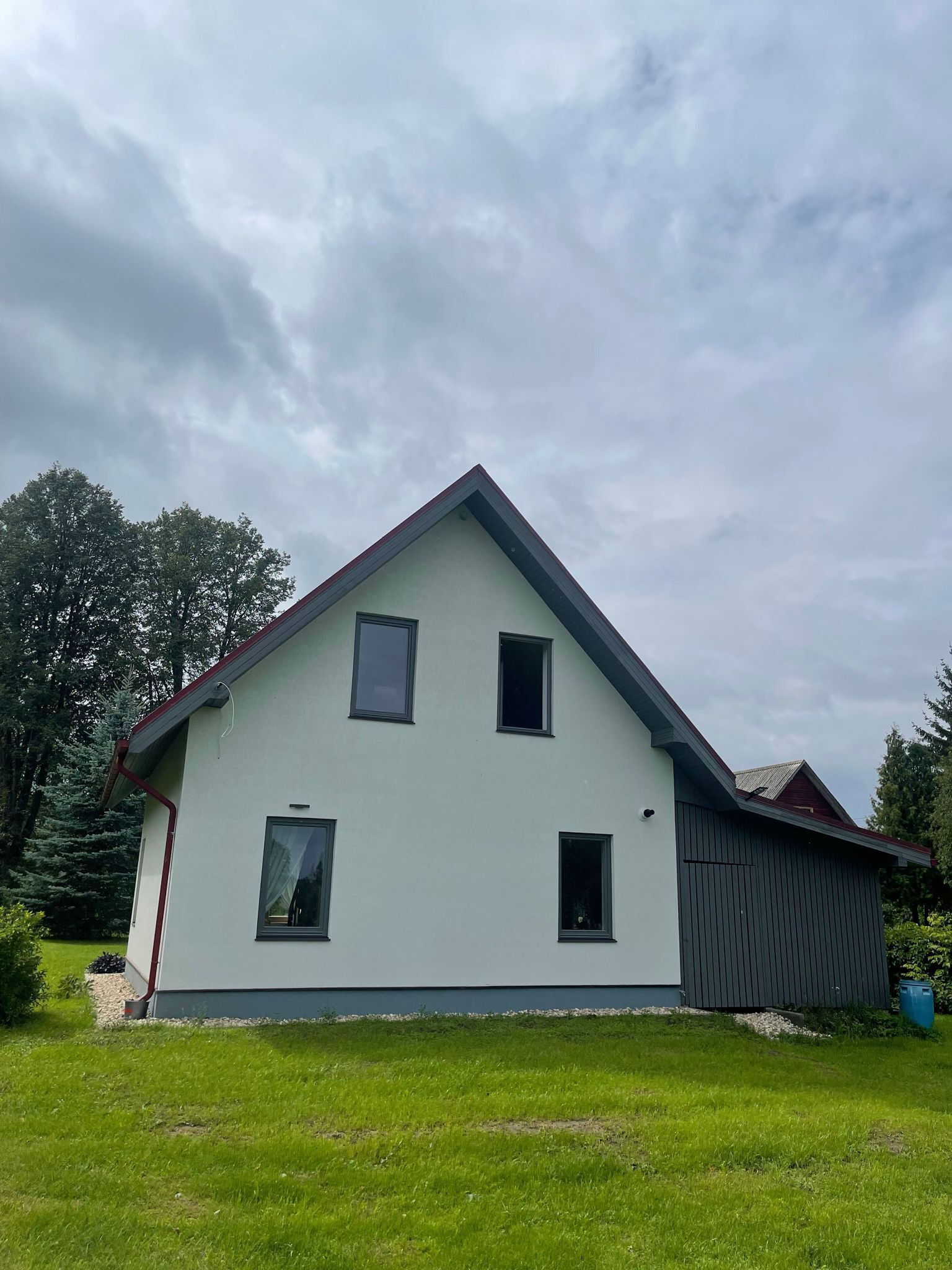 A single-story house with a gabled roof, a front porch, and a small attached garage.