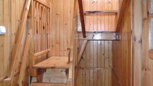 A wooden staircase leading to a loft area with a slanted ceiling. - House in Wiselka Near Baltic Sea Beach (Międzyzdroje)