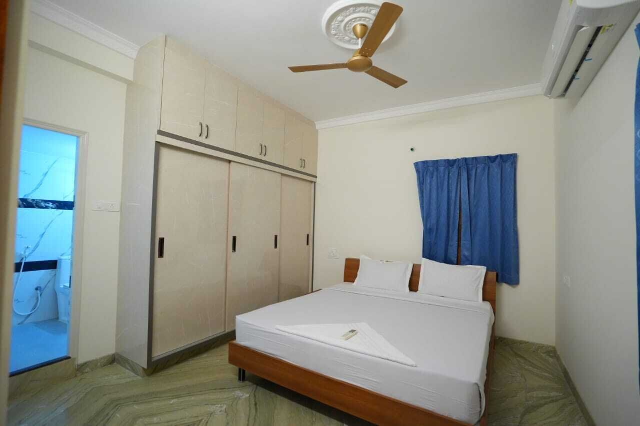 Un dormitorio con cama, armario, ventilador de techo y aire acondicionado.