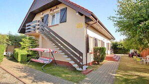 A two-story building with a staircase leading to the upper floor. - Apartment in Rowy Near Baltic Sandy Beach (Ustka)
