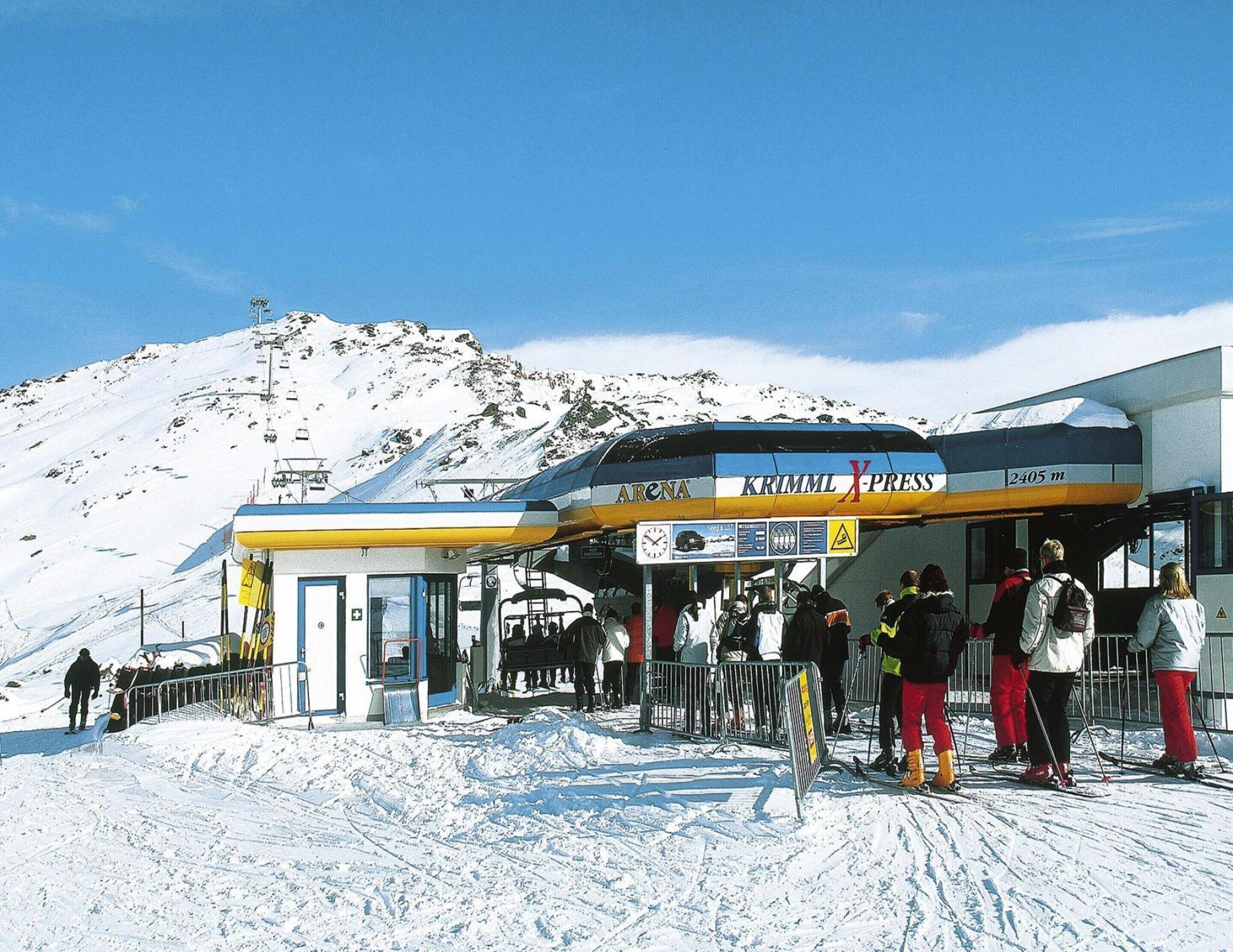 A ski lift station with a mountain in the background.