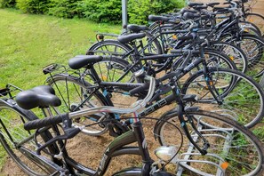 A row of bicycles parked outdoors, likely in a public or communal area. - Comfortable Ground Floor Apartment, Summer Pool (Mielno)