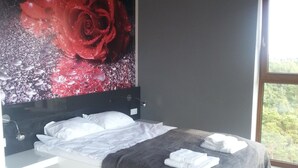 A bedroom with a bed, a grey blanket, and a white pillow. - Apartment in Dziwnowek Near the Beach (Dziwnów)