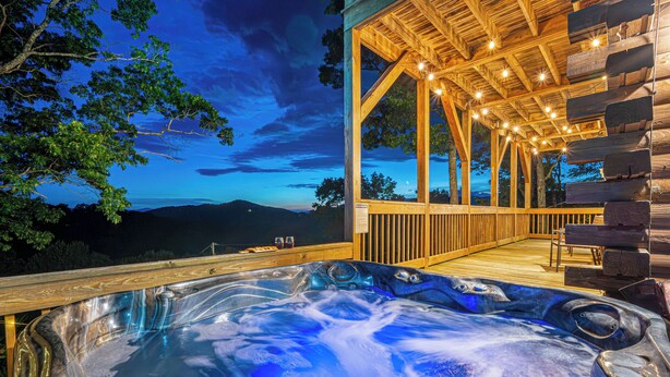 A hot tub with a wooden deck and a view of the mountains. - Cabin On 8-Private Acres, Hot Tub, Game Room, Views (Bryson City)
