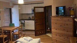A compact living space with a dining area, kitchenette, and a TV on a dresser. - Apartment in Pobierowo Near Baltic Sea Beach (Rewal)