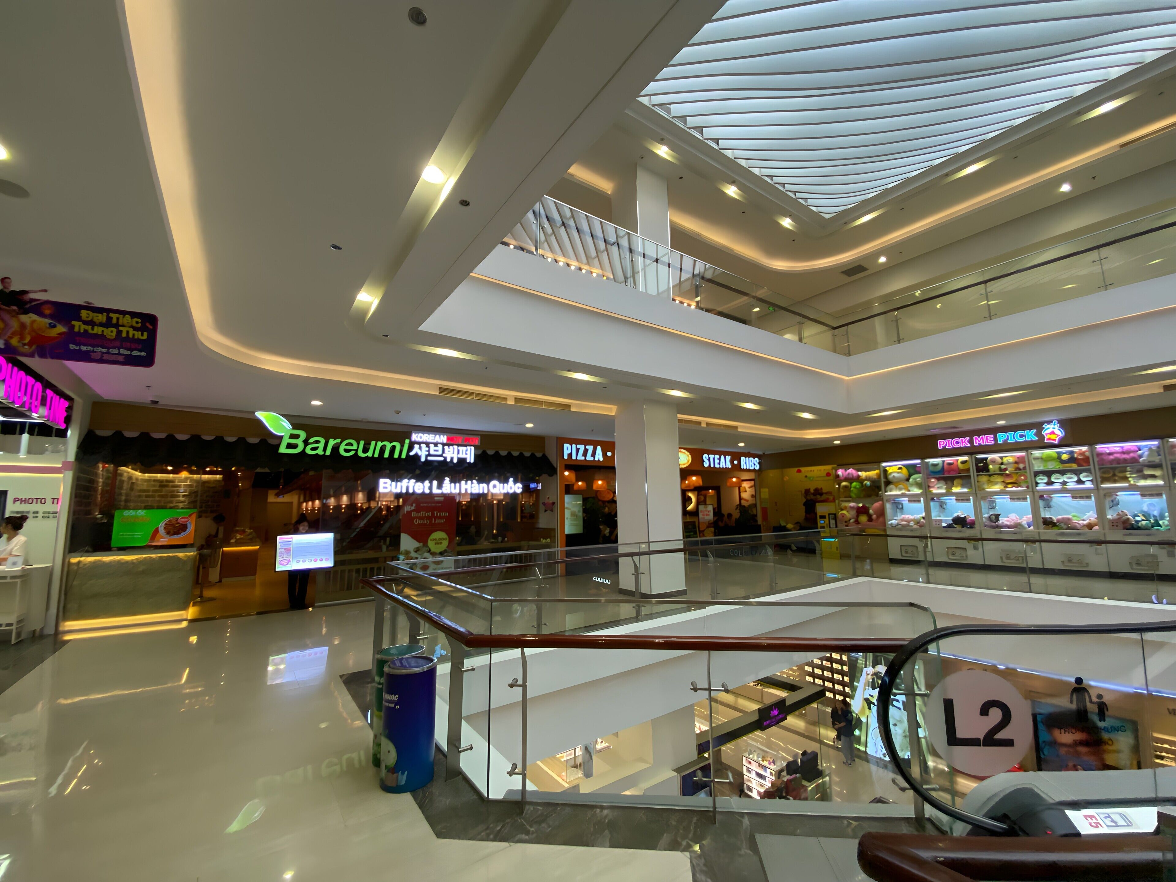 A multi-level shopping mall with various stores, including a buffet restaurant and a pizza place.