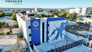 A building with a large mural of a jellyfish on its side, a sign for Mandala Medusa, and a view of the surrounding area. - Condo a 3 blocks from La Paz Malecon (La Paz)