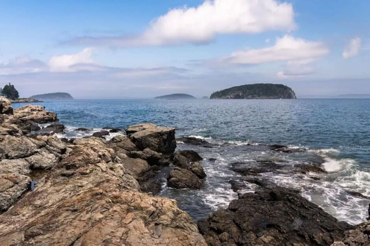 A rocky coastline with waves crashing against the rocks.