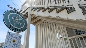 A building with a sign for 'Seaside Suites' and a QR code. - Stylish 1BR Suite Steps to the Beach 467 (Old Orchard Beach)