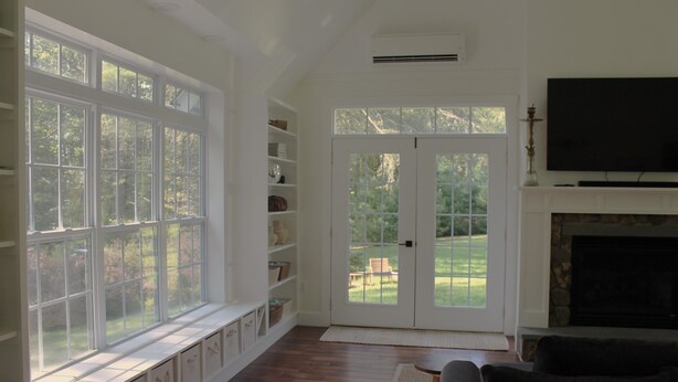 A living room with a fireplace, large windows, and a television. - Corkscrew Cape - Family Friendly Upstate NY Escape (Barryville)