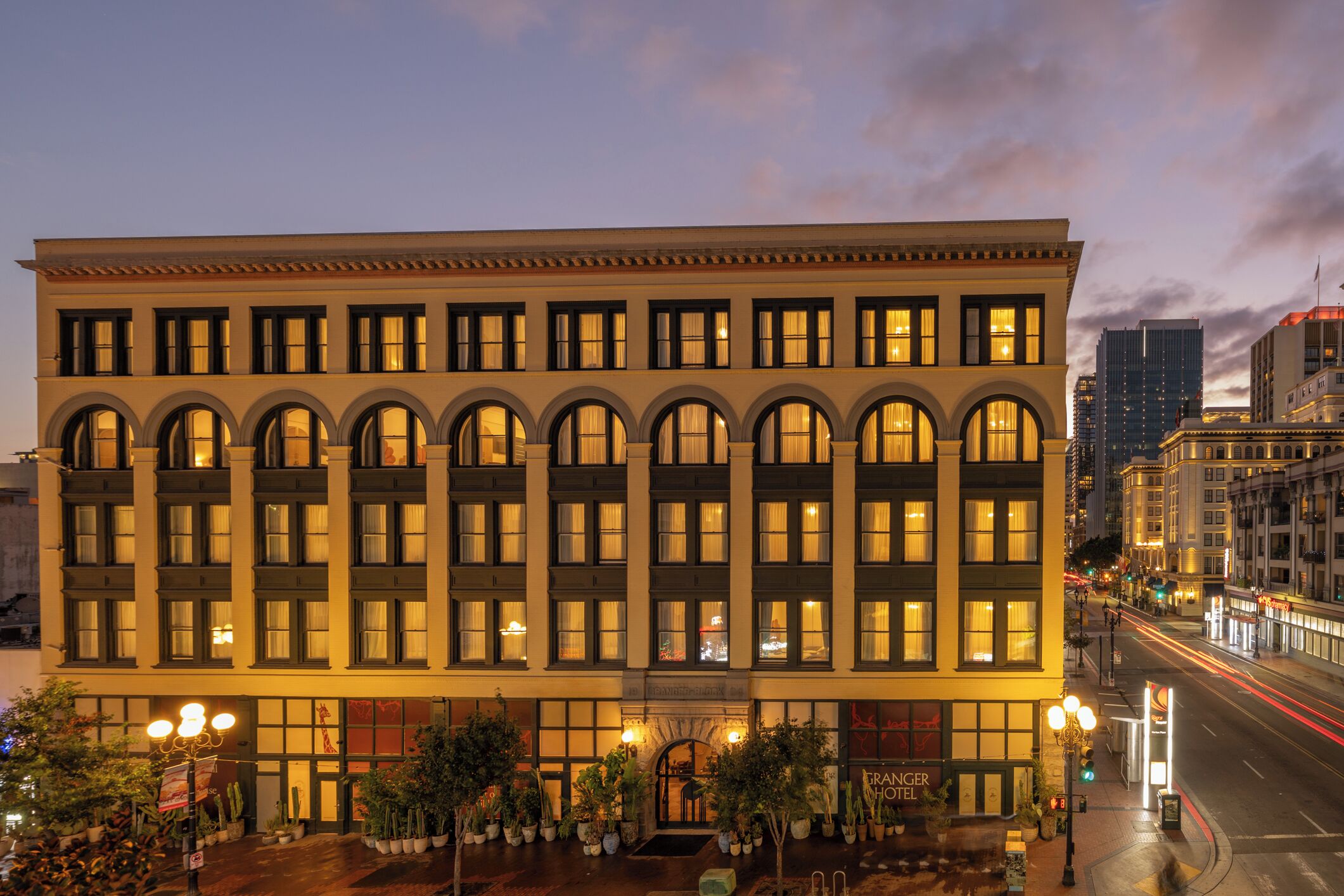 A multi-story hotel with a symmetrical facade, large windows, and a central entrance with a canopy.