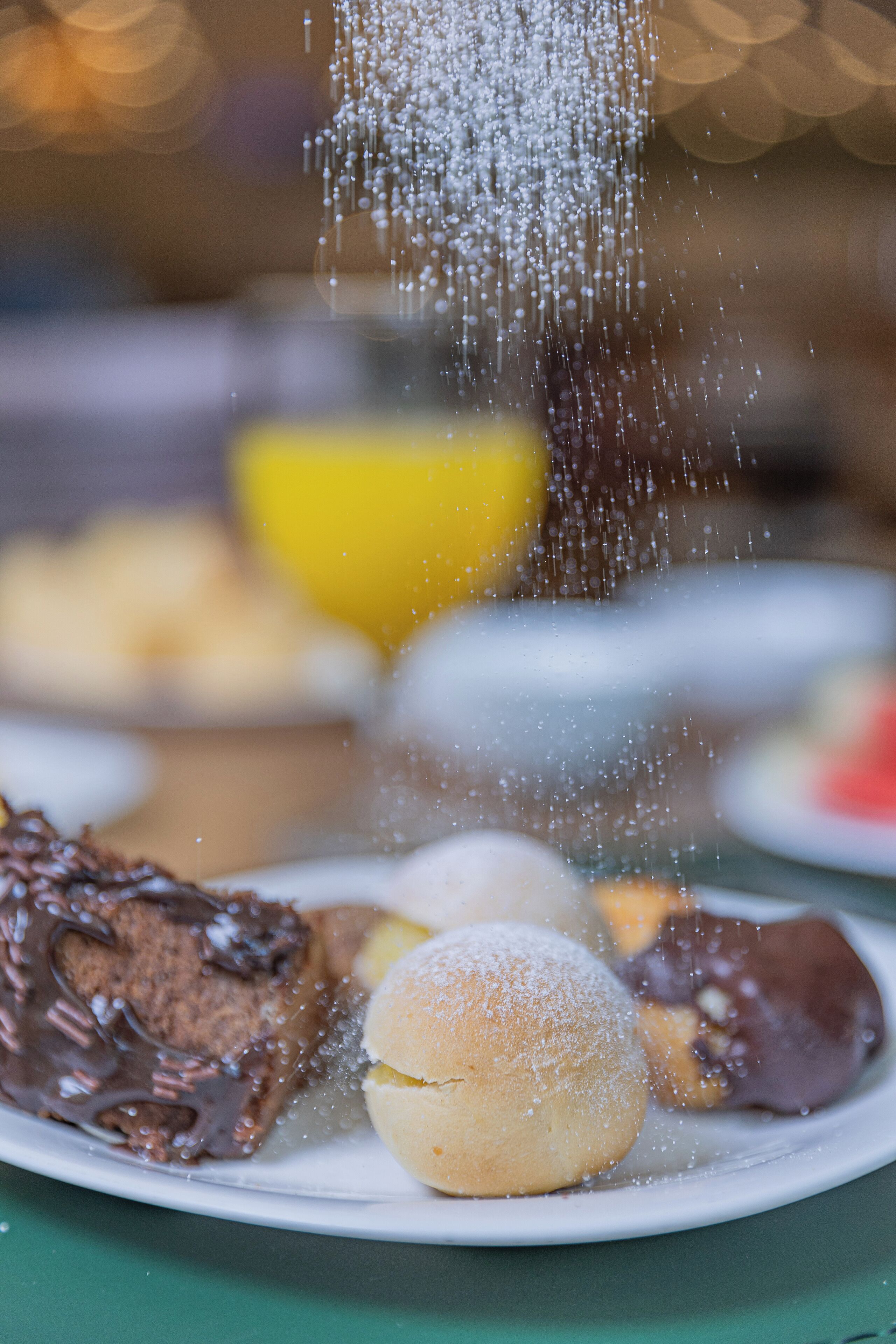 A dessert plate with various sweets and a lemon slice.