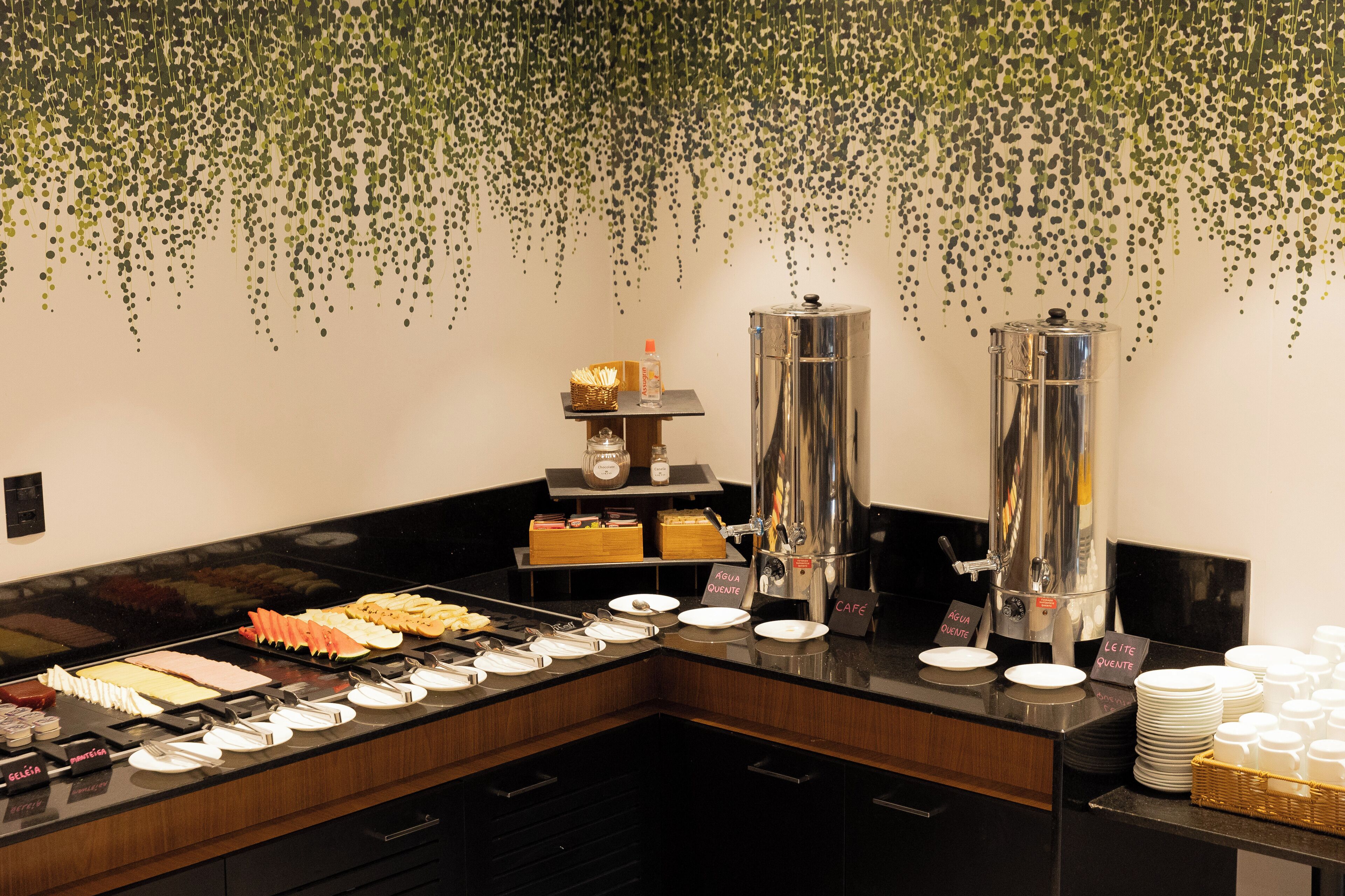A buffet setup with various food items and beverage dispensers.