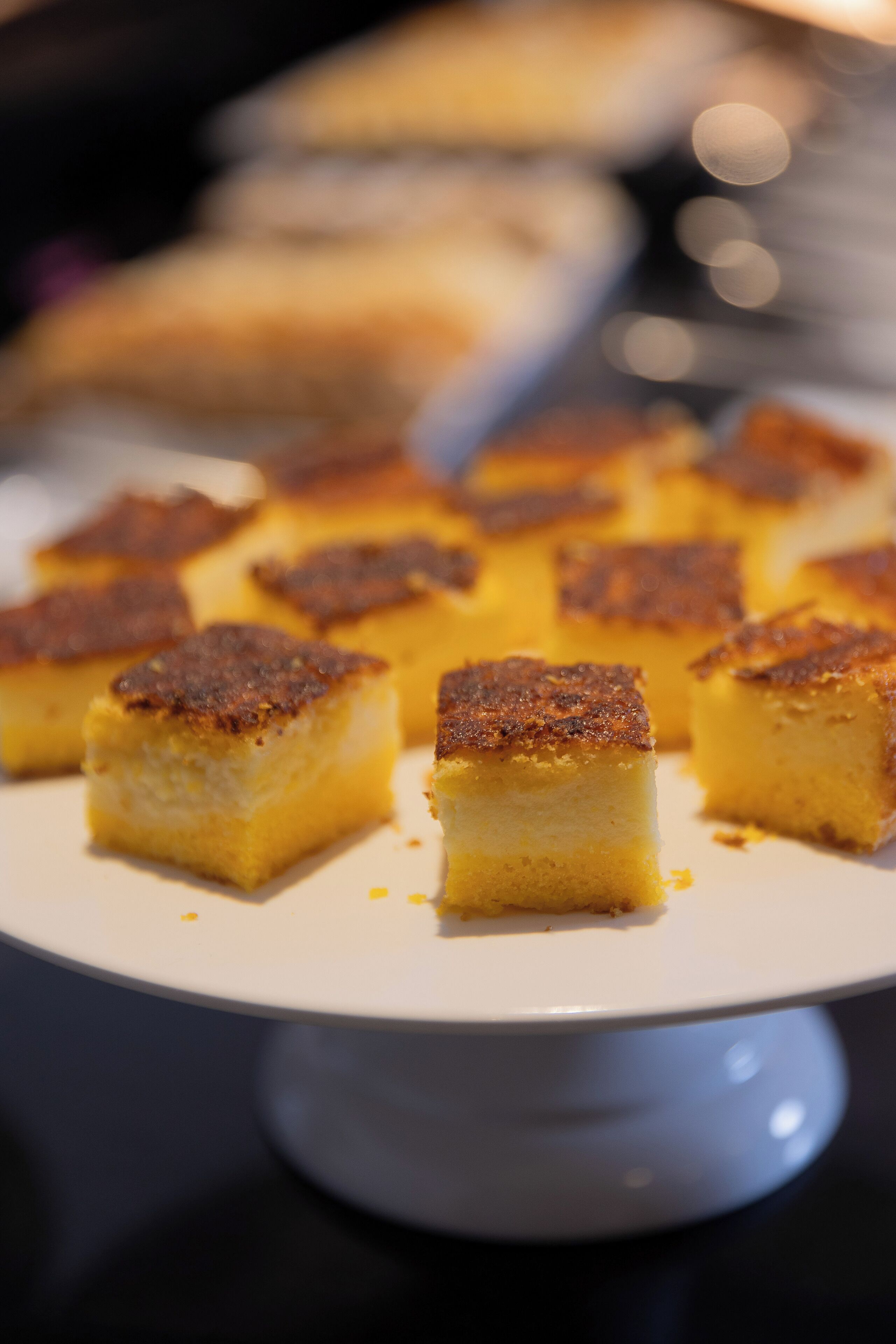 A dessert plate with several square pieces of cake on a white plate.