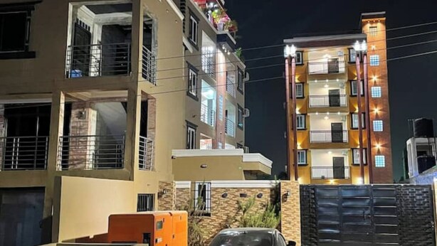 A multi-story residential building with balconies and a gated entrance. - Nice apartment with AC in Greater Accra Region (Greater Accra Region)