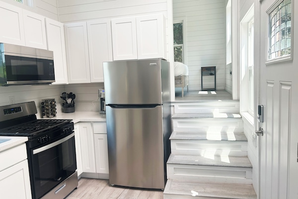 Full kitchen with sink, stove, microwave, dishwasher, refrigerator, coffee maker