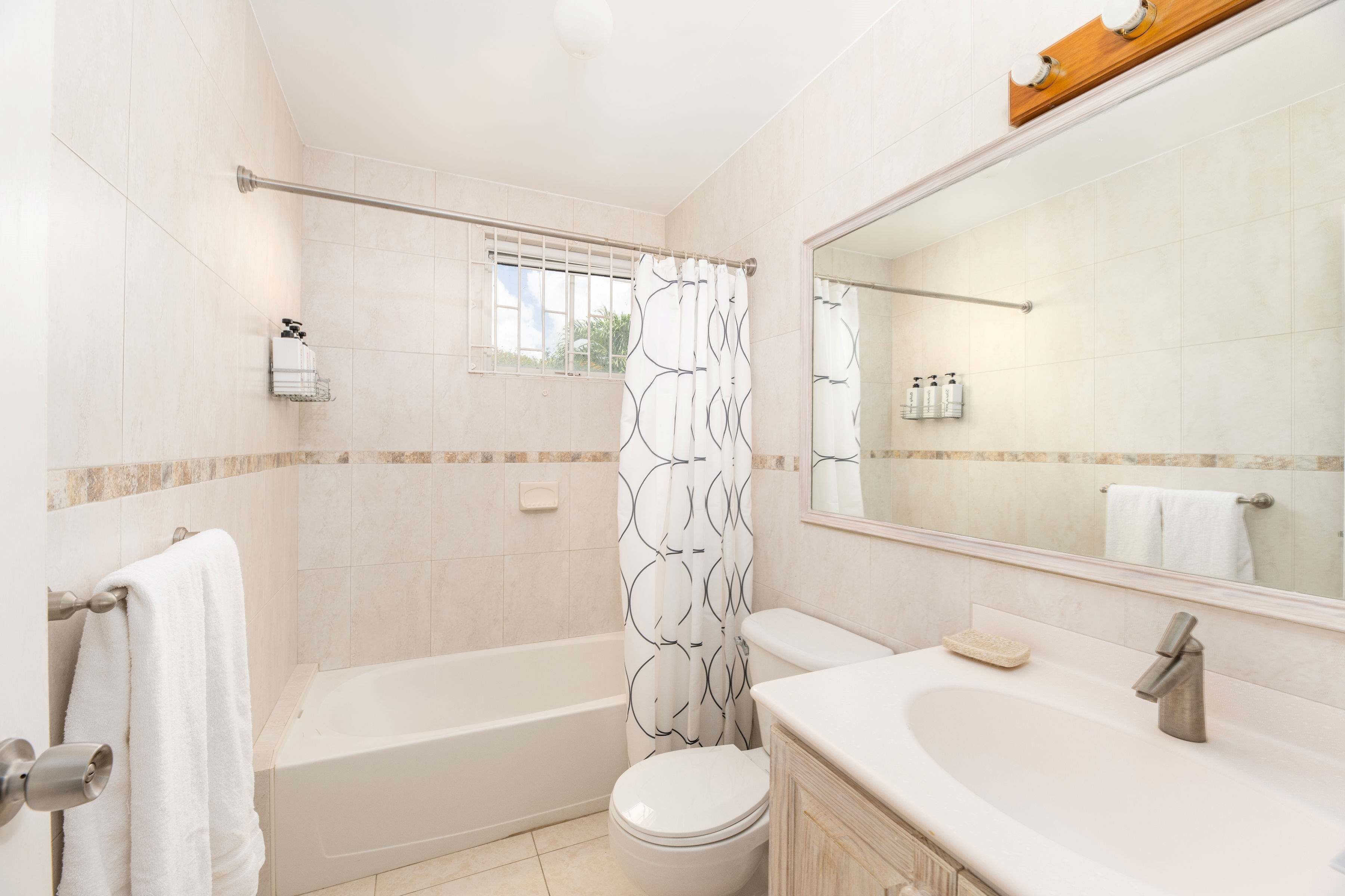 A bathroom with a bathtub, toilet, and sink.