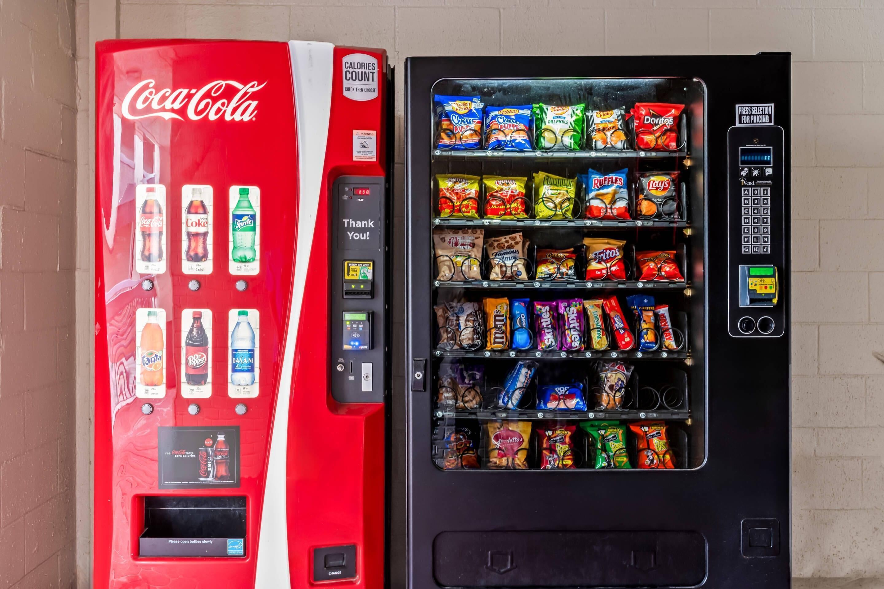 A Coca-Cola vending machine and a snack vending machine.