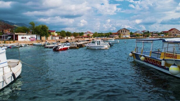 A marina with boats docked, a clear sky, and buildings in the background. - Apartments Adriana - Studio Apartment A2+1 (Starigrad-Paklenica)