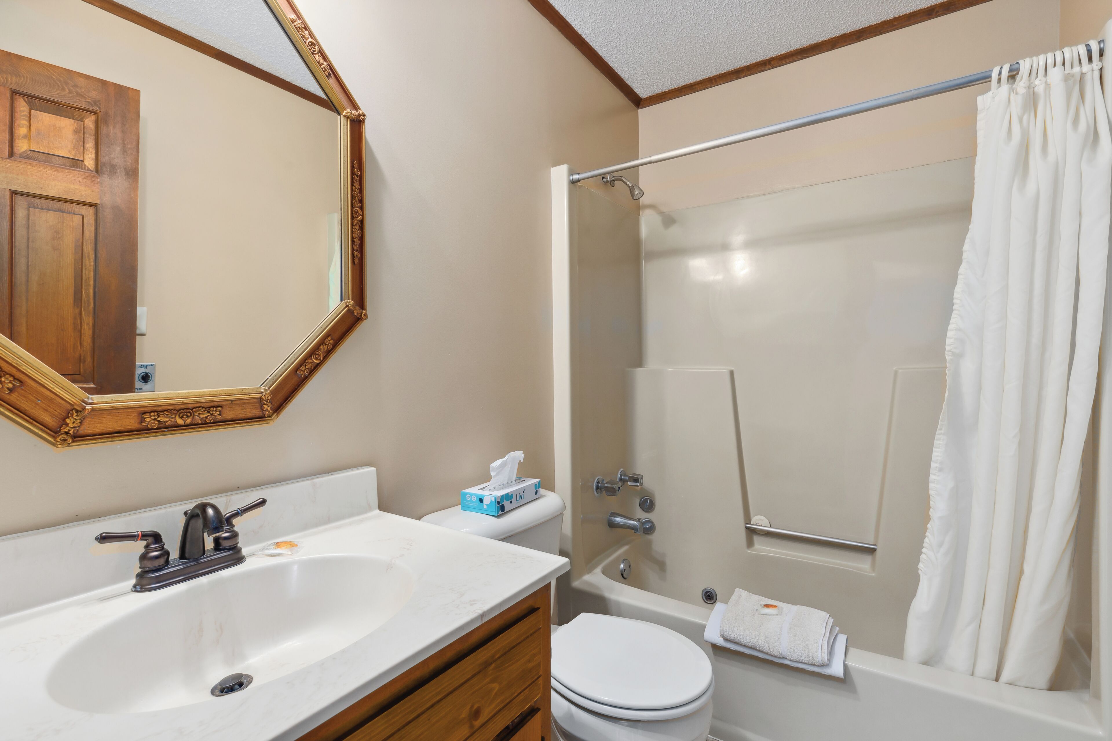 A bathroom with a sink, toilet, and bathtub.