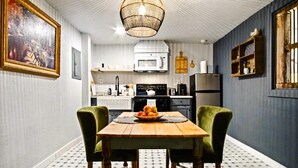 A kitchen with a dining table, chairs, a microwave, and a refrigerator. - Harmony Studio 5min-asian Dist Full Kitchen (Oklahoma City)