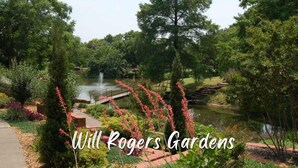 A serene park with a pond, a bridge, and lush greenery. - Harmony Studio 5min-asian Dist Full Kitchen (Oklahoma City)