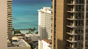 A high-rise hotel with a view of the ocean and beach.
