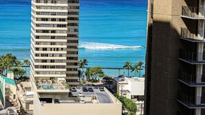 A high-rise hotel with a view of the ocean.