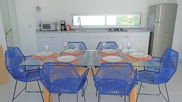 A modern kitchen with a dining area.