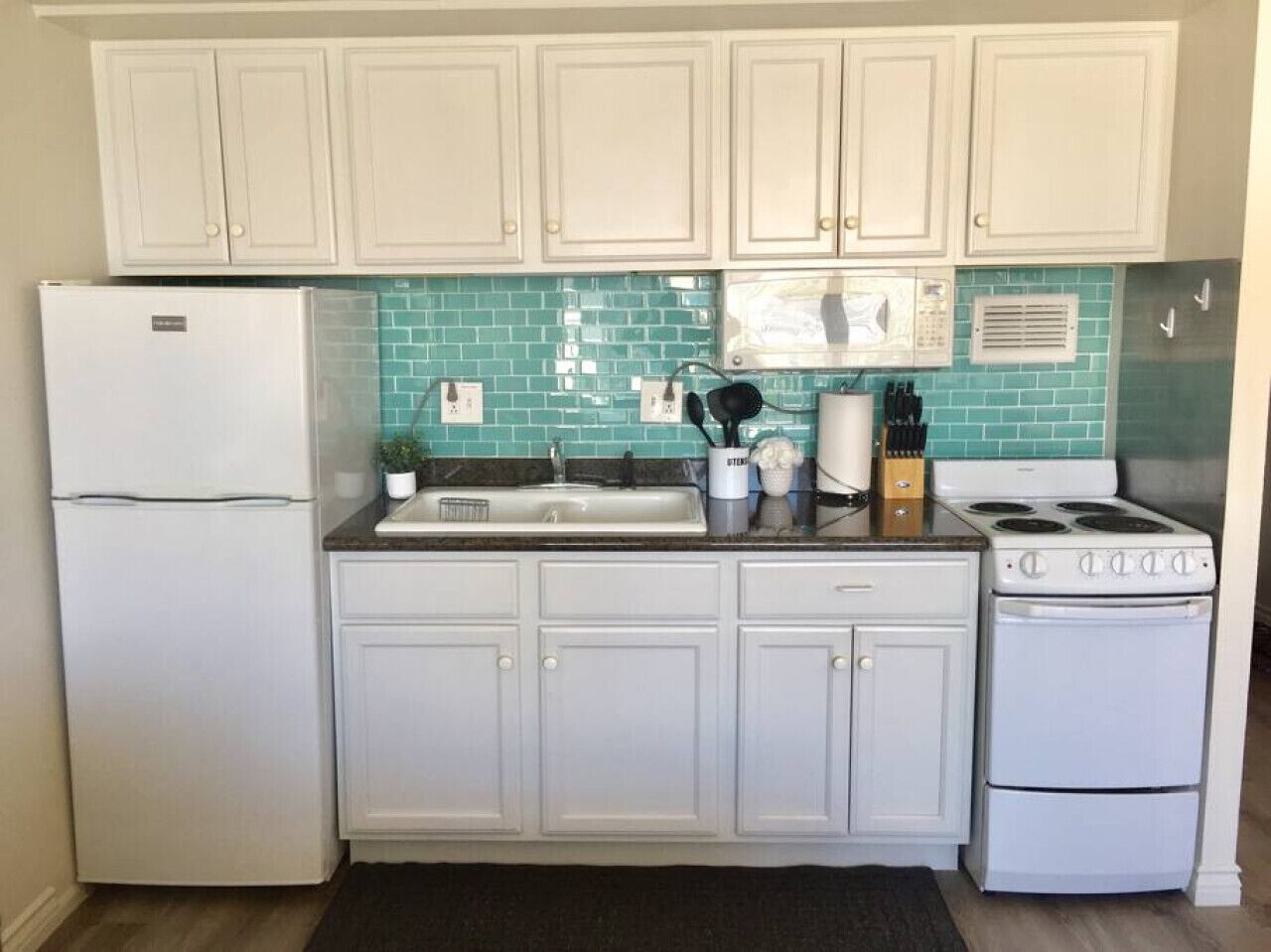 Fridge, microwave, coffee/tea maker, cookware/dishes/utensils