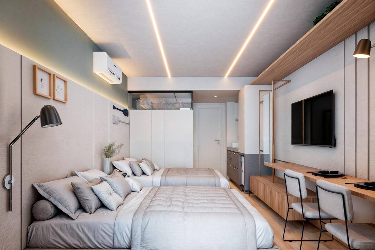 A modern bedroom with a bed, bedside tables, a desk, and a TV.