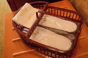 A wooden chair with a plastic bag on it. - Dingxi Jingu Hotel (Dingxi)