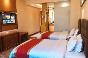 A hotel room with two beds, a TV, a wardrobe, and a mirror. - Dingxi Jingu Hotel (Dingxi)