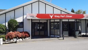 A building with a red banner reading "Stag Park Diner" and a clear entrance.