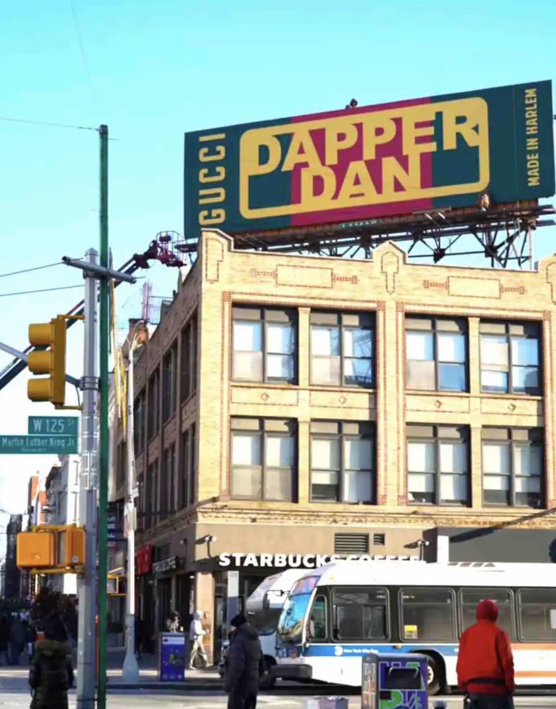 A street view with a building featuring a large billboard advertising 'GUCCI DAPPER DAN'.