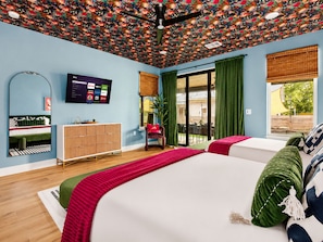 A modern bedroom with a large bed, a TV mounted on the wall, and a view of the outdoors through a sliding door. - Downtown Austin Luxury Stay ★ Hot Tub • Fire Pit • Minigolf (Austin)