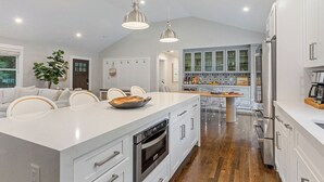 A modern kitchen with a large island, stainless steel appliances, and pendant lighting. - Upscale Secluded Home w/Central AC, Pool & Firepit (Centerville,)