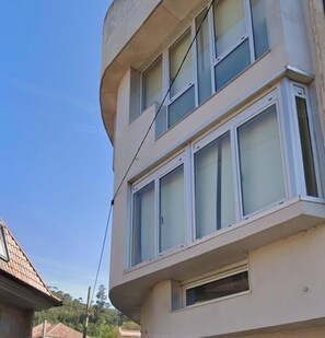 A multi-story building with large windows and a flat facade.
