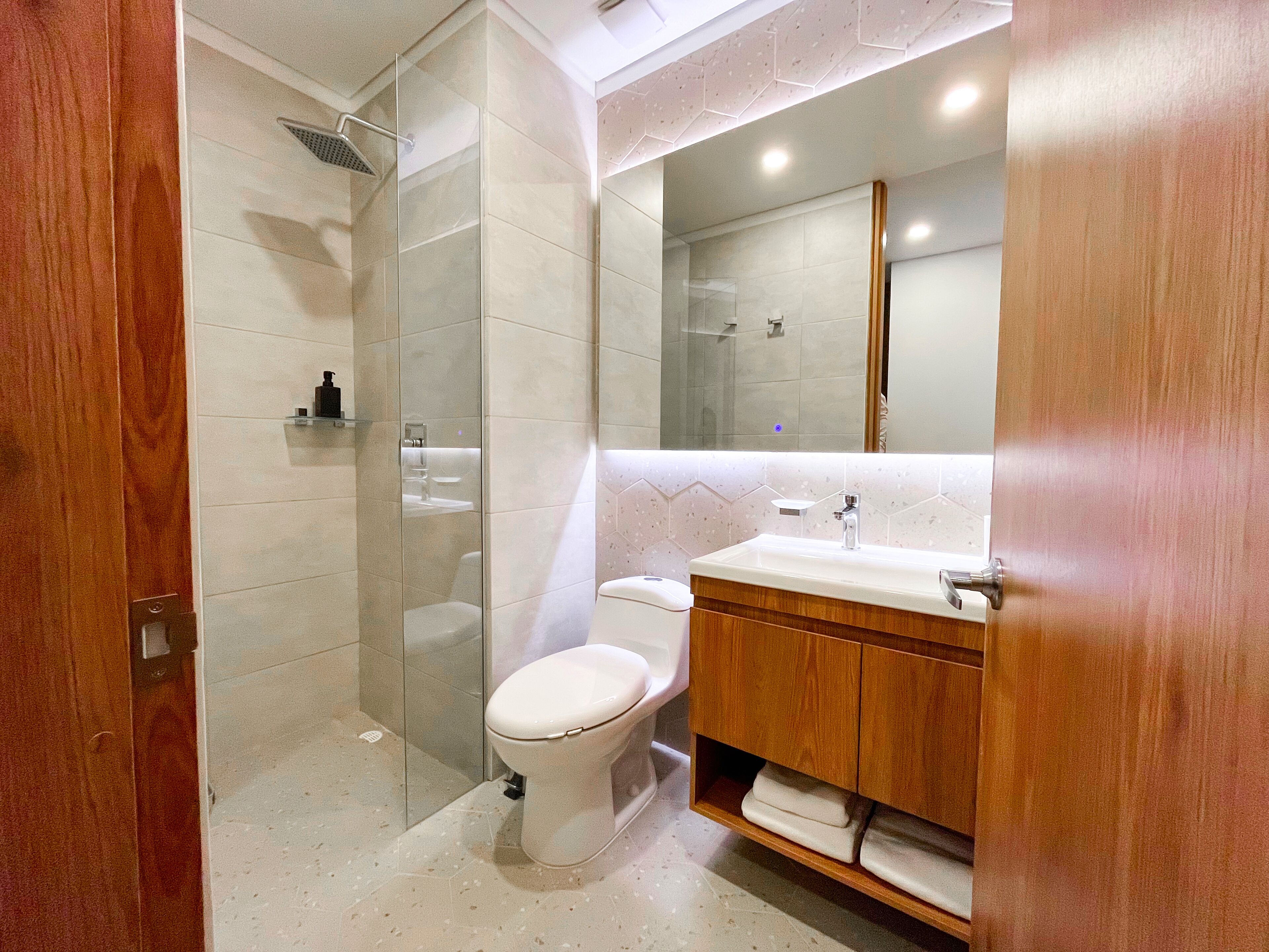 Shower, rainfall showerhead, hair dryer, towels