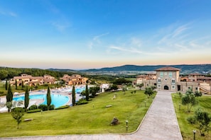 A resort with a swimming pool, a central building, and surrounding villas.
