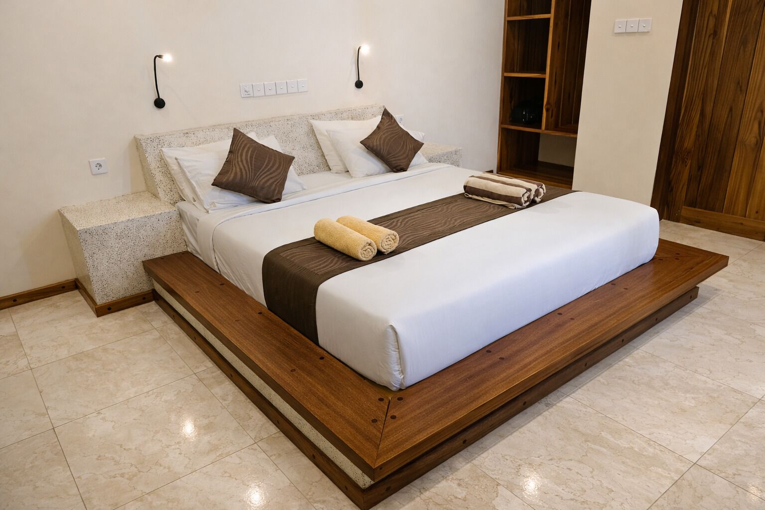 A modern bedroom with a large bed, wooden headboard, and a built-in bench.