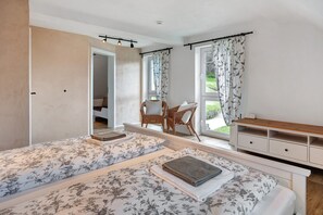 A bedroom with two beds, a desk, and a chair. - Apartment 'Ferienwohnung Rinkenberg' with Private Terrace and Wi-Fi (Baiersbronn)