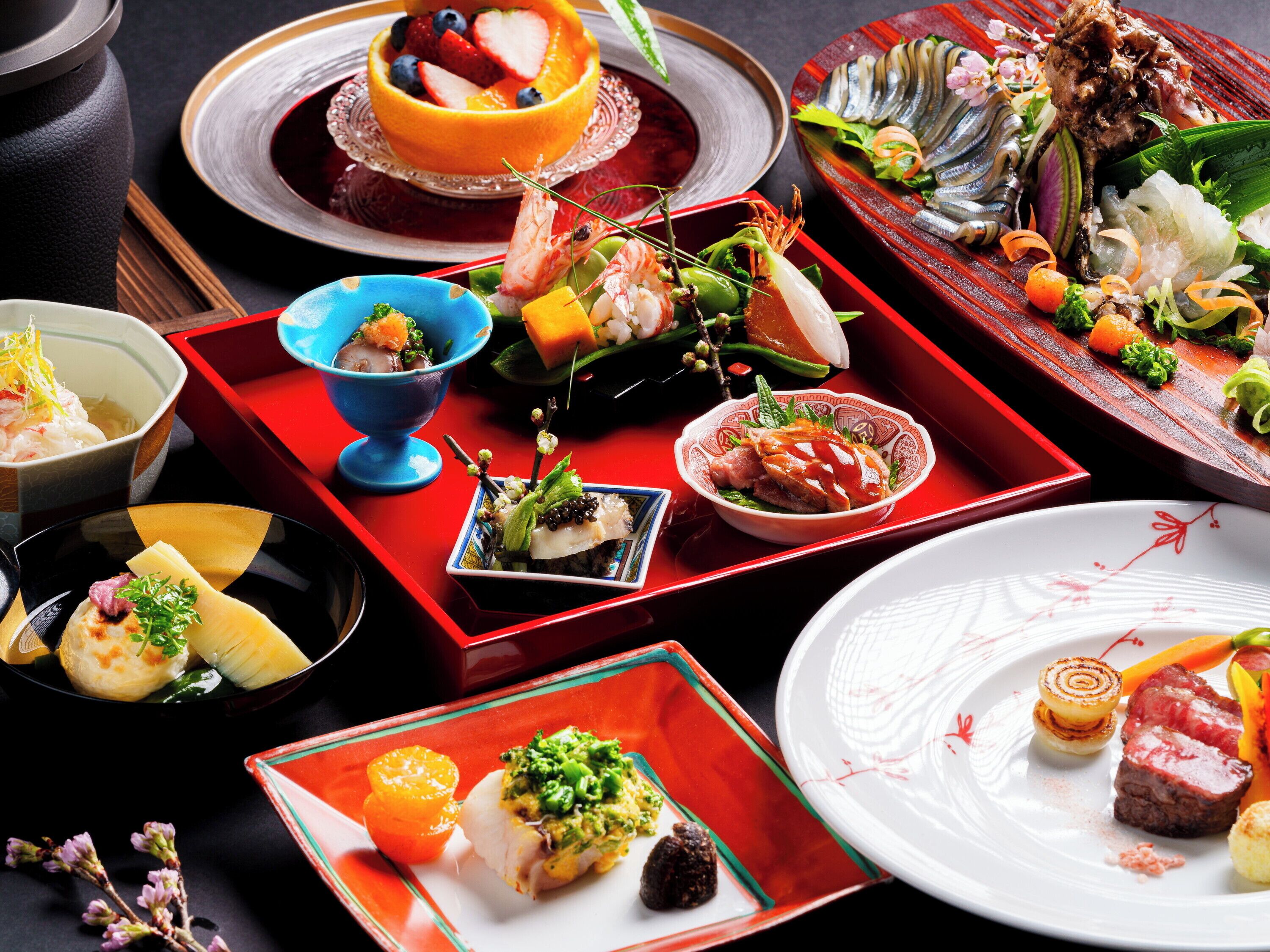 A variety of dishes arranged on a table, including seafood, vegetables, and fruits.