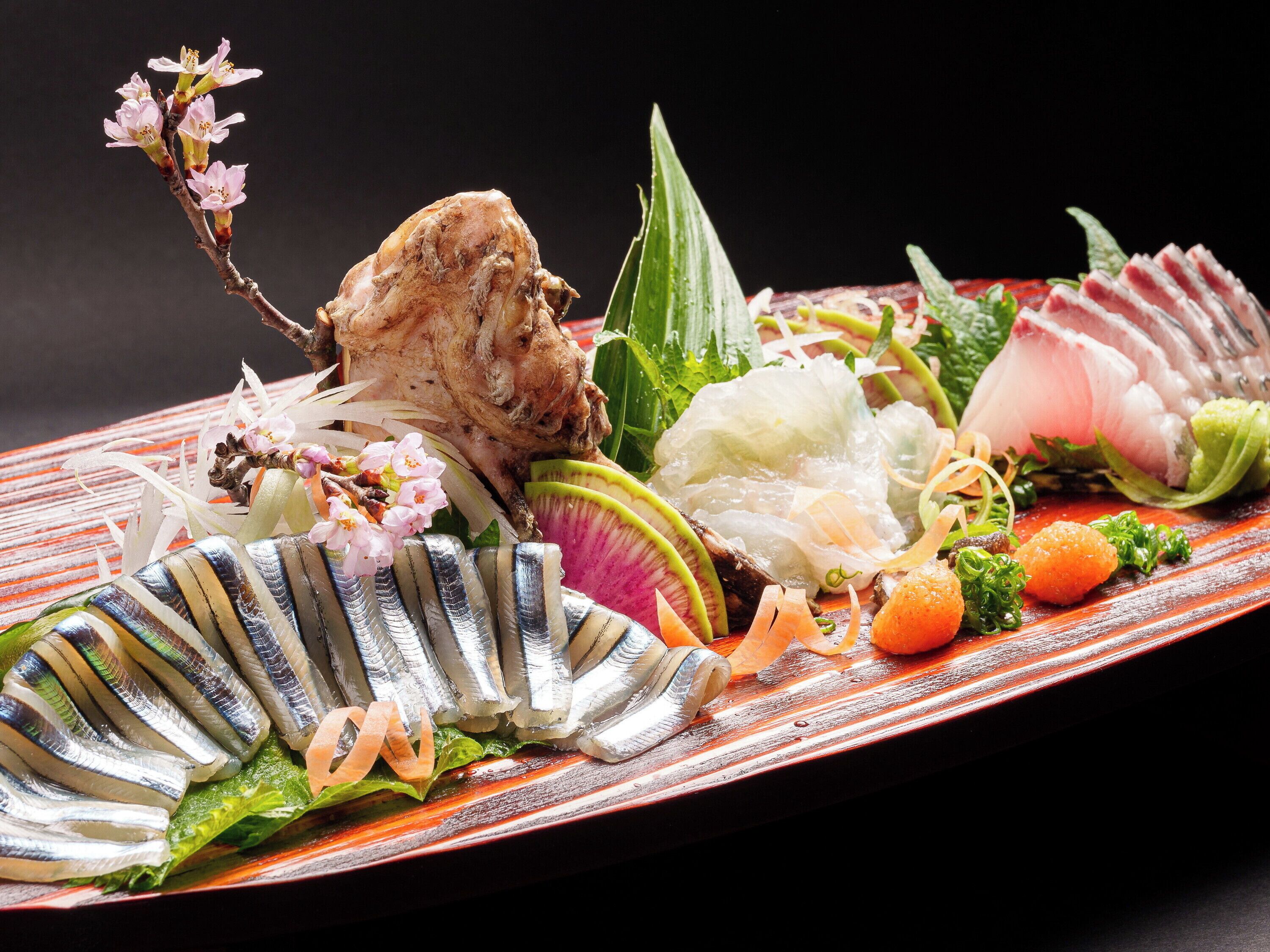 A sushi platter with various ingredients and decorations.